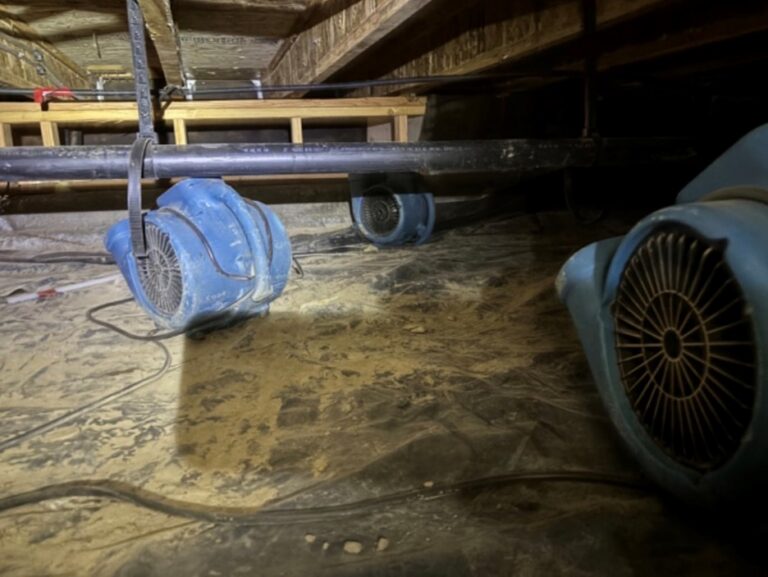 Air movers drying out water damaged crawl space
