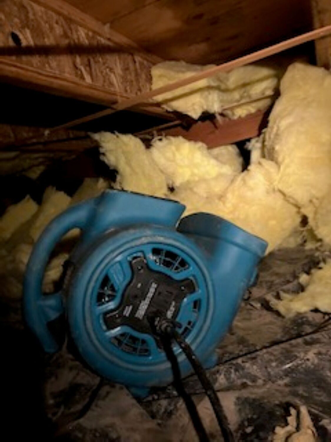 Water damaged crawlspace with saturated insulation being removed in Madras Oregon home