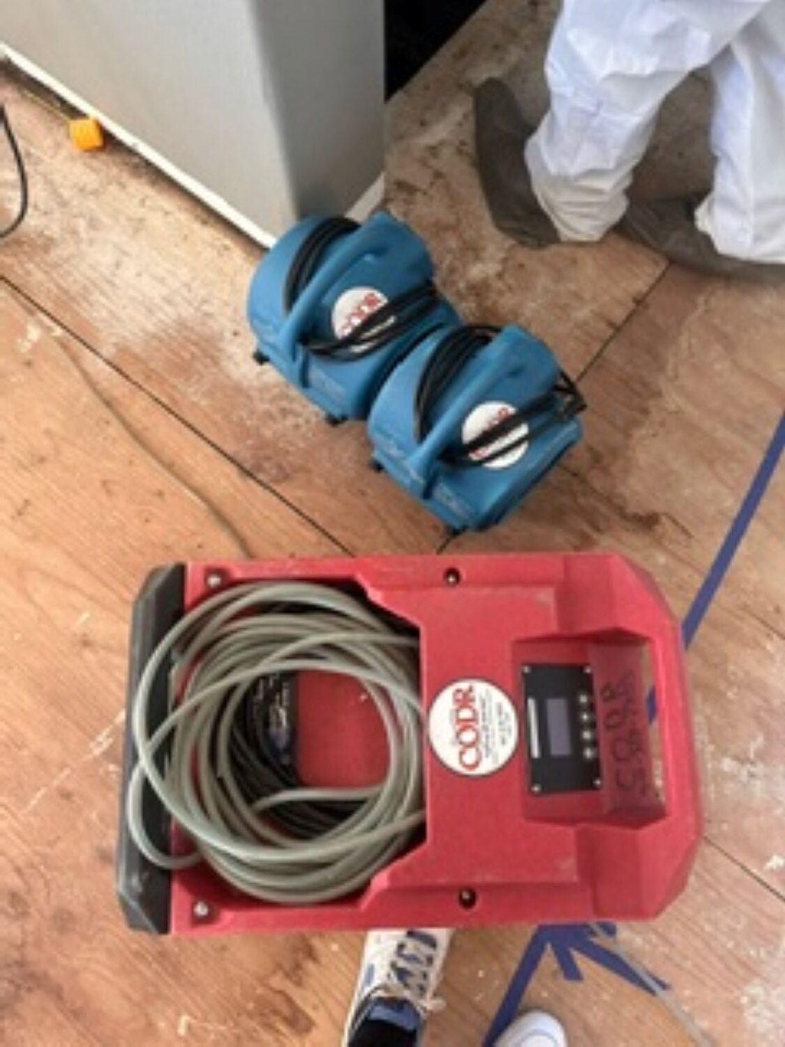 Air movers and dehumidifiers set up in kitchen during water damage drying process