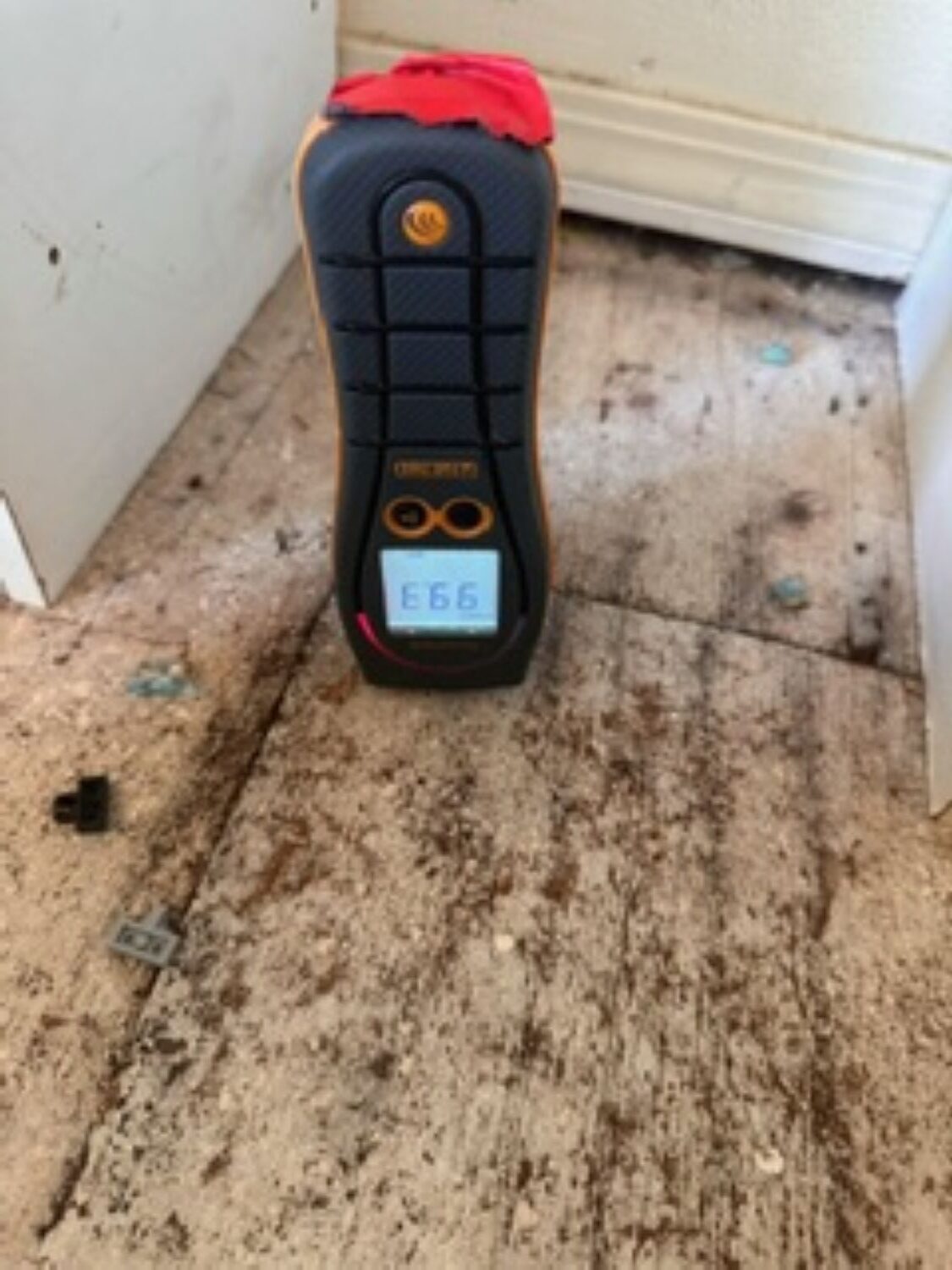 Exposed subfloor showing water damage beneath kitchen flooring