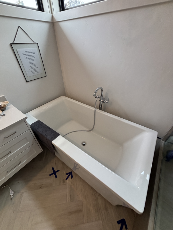 Technician taking moisture readings in water-damaged bathroom in Bend OR