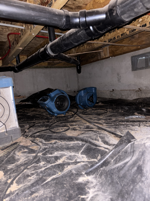 Drying equipment running in crawlspace below water damaged bathroom in Bend Oregon