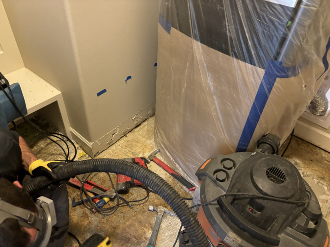 Selective demolition in laundry room with tile and underlayment removed