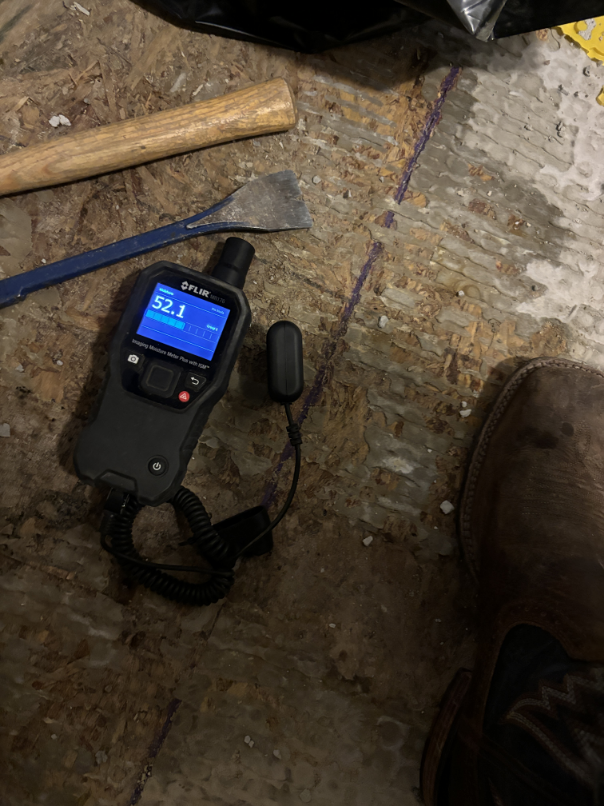 Moisture meter readings on affected walls during water damage assessment