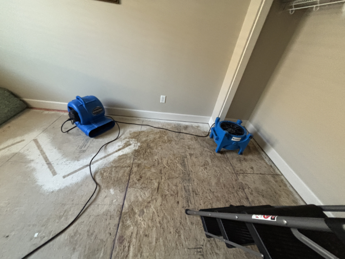 Air movers and dehumidifiers running during structural drying process