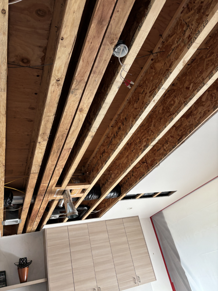 Close-up of ceiling water damage showing staining and drywall deterioration in kitchen