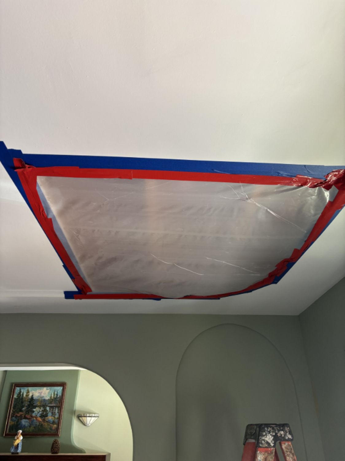 Ceiling opened up during water damage mitigation to access wet insulation