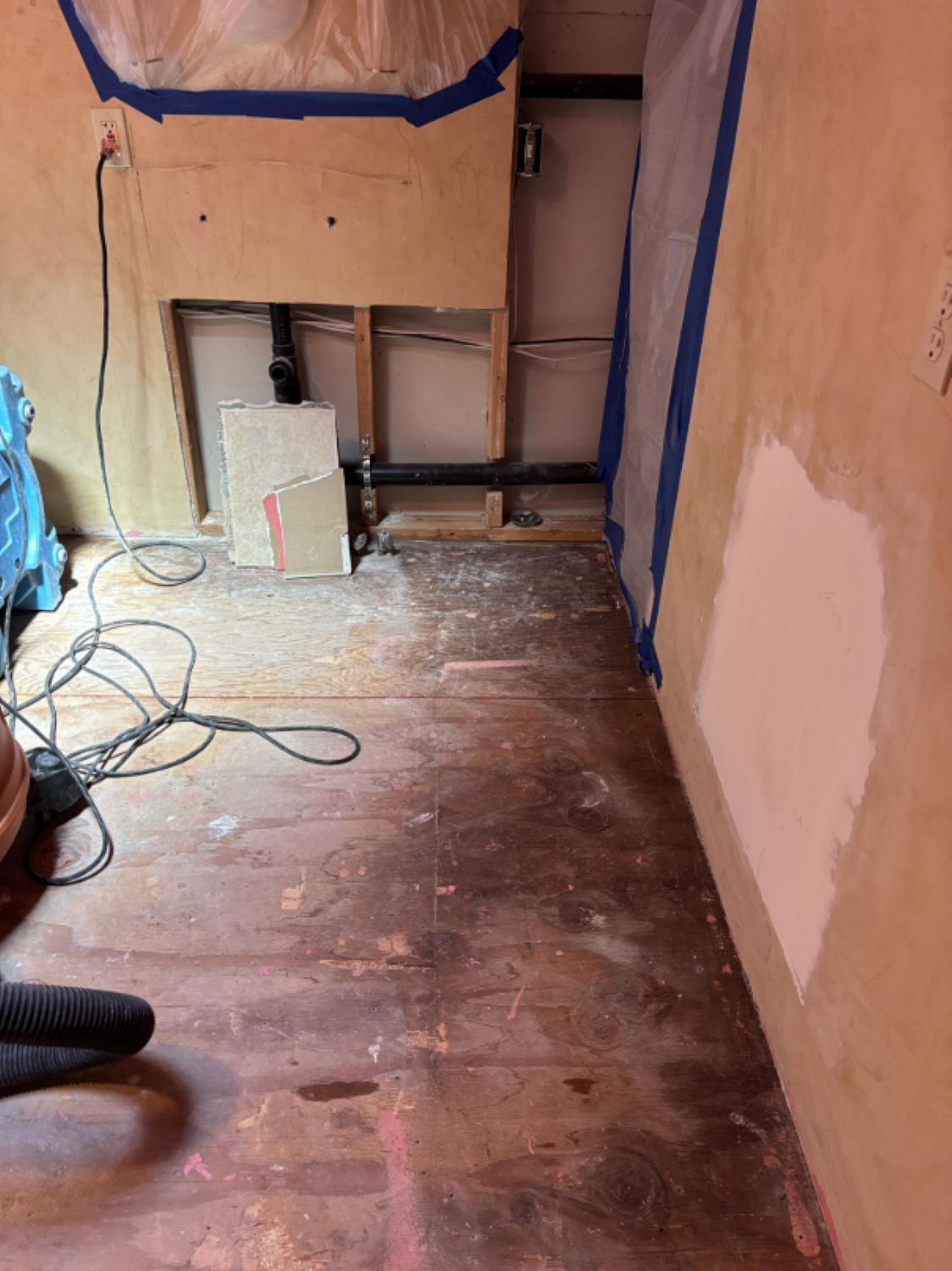 Flooring area during water damage mitigation with drying equipment in place