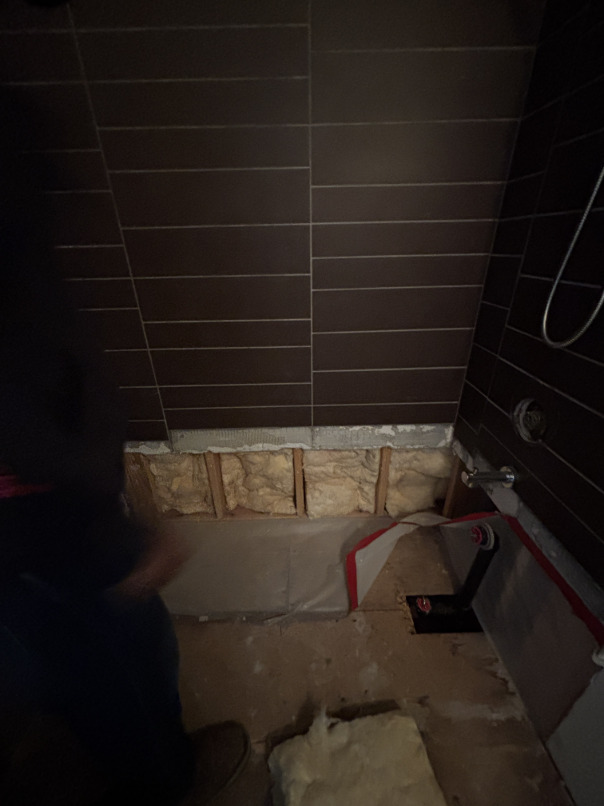 Fresh insulation installed in wall cavity after water-damaged insulation was removed