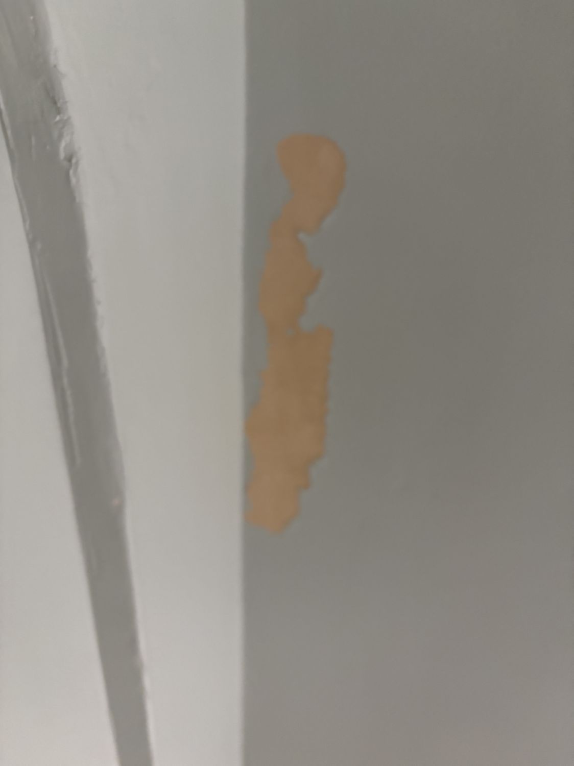 Chipped and damaged wall showing water intrusion from roof leak in Bend home