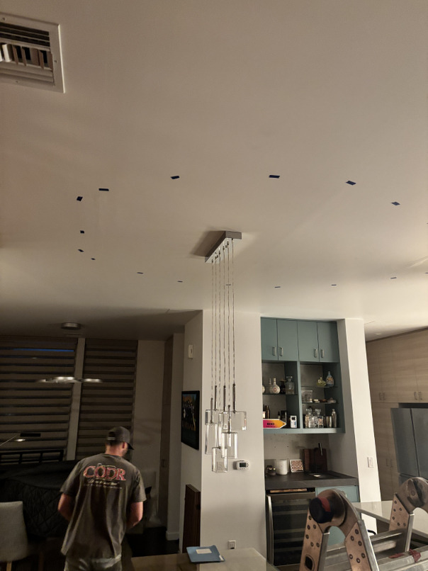 Industrial air movers positioned on main level floor during water damage drying process
