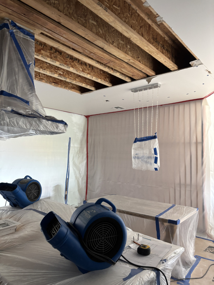Drying equipment running in condo hallway and stairwell during water damage mitigation
