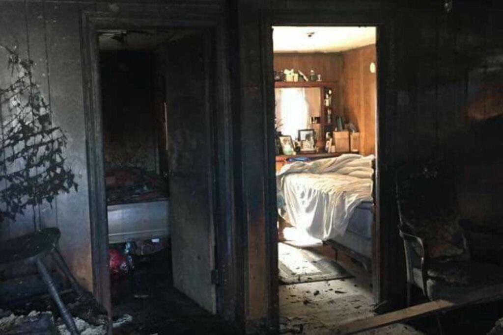 Smoke and soot damage in a bedroom after a fire in Bend