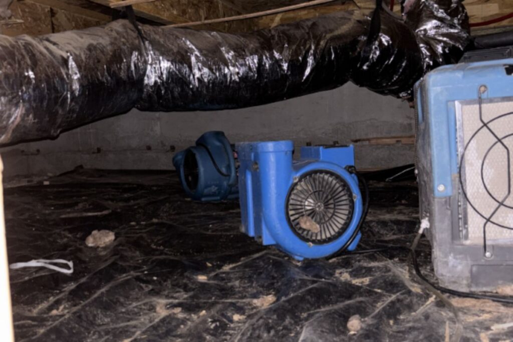 Air movers and dehumidifier drying a crawl space in Bend, OR